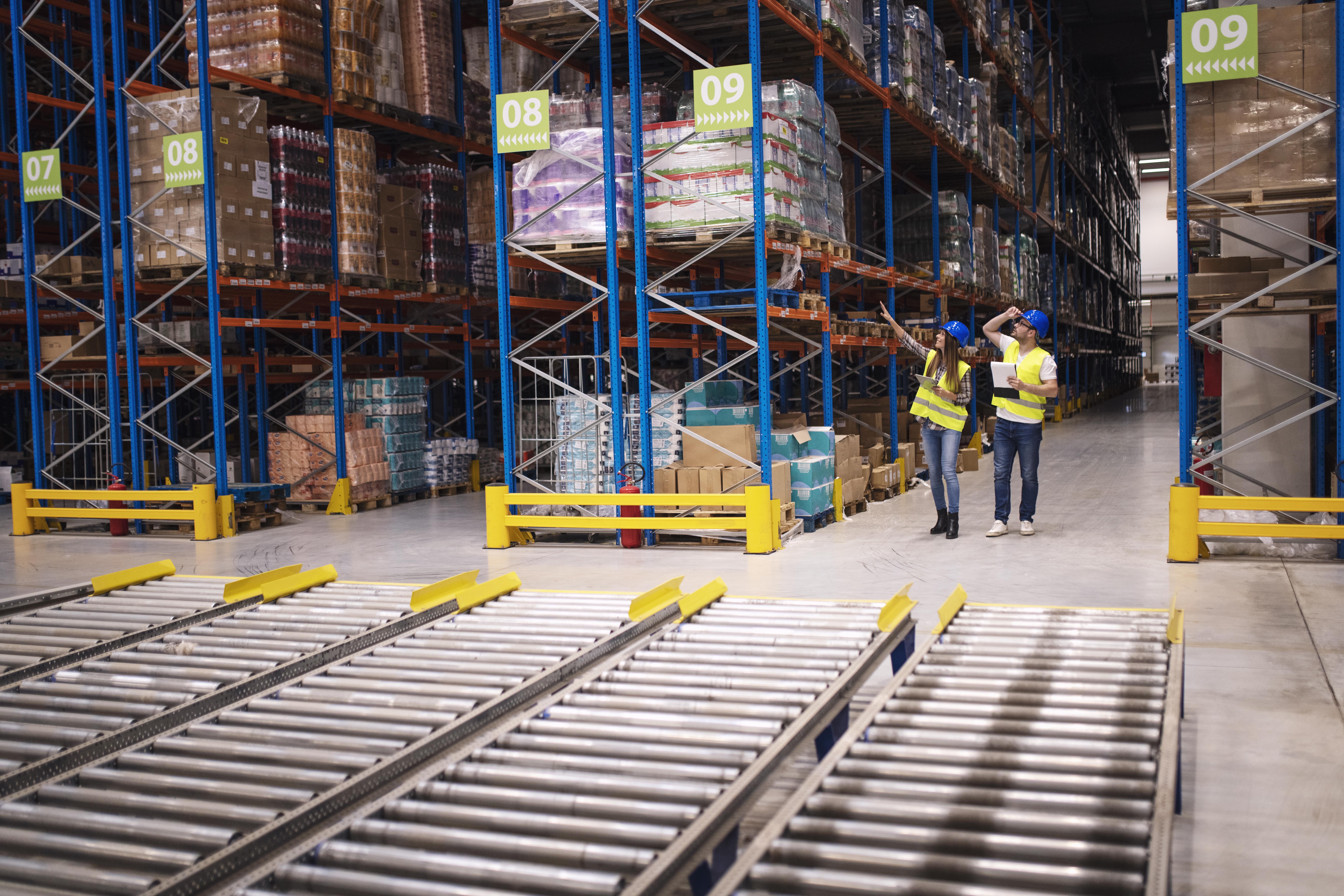 warehouse-workers-checking-inventory-goods-distribution-large-storehouse